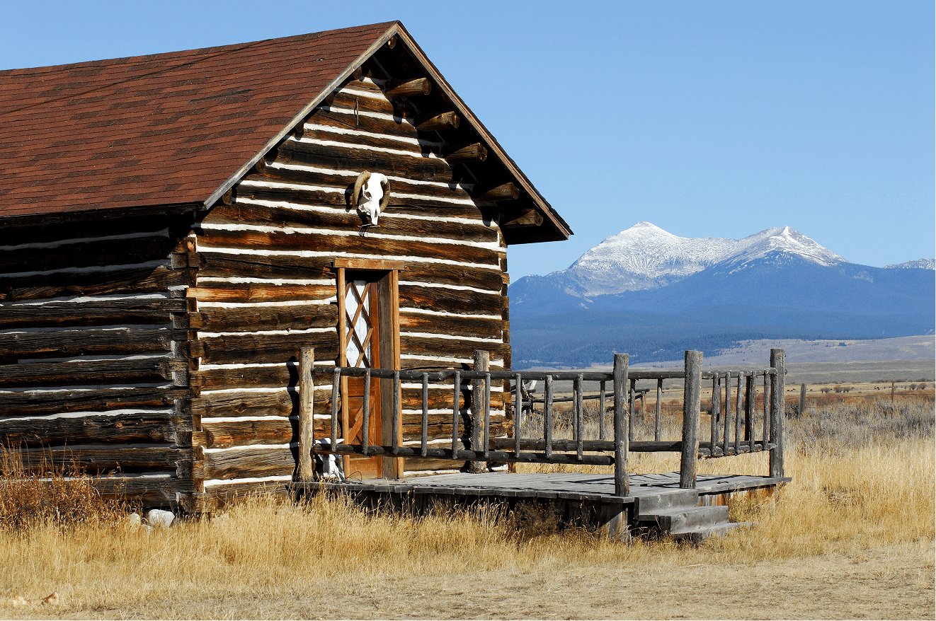 Log cabin in grassy field